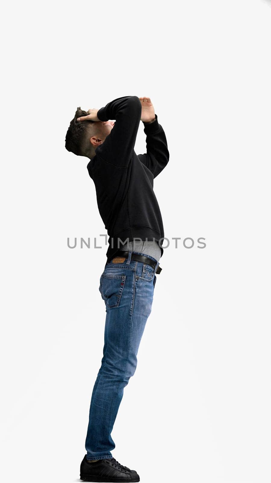 A man, full-length, on a white background, facepalm.