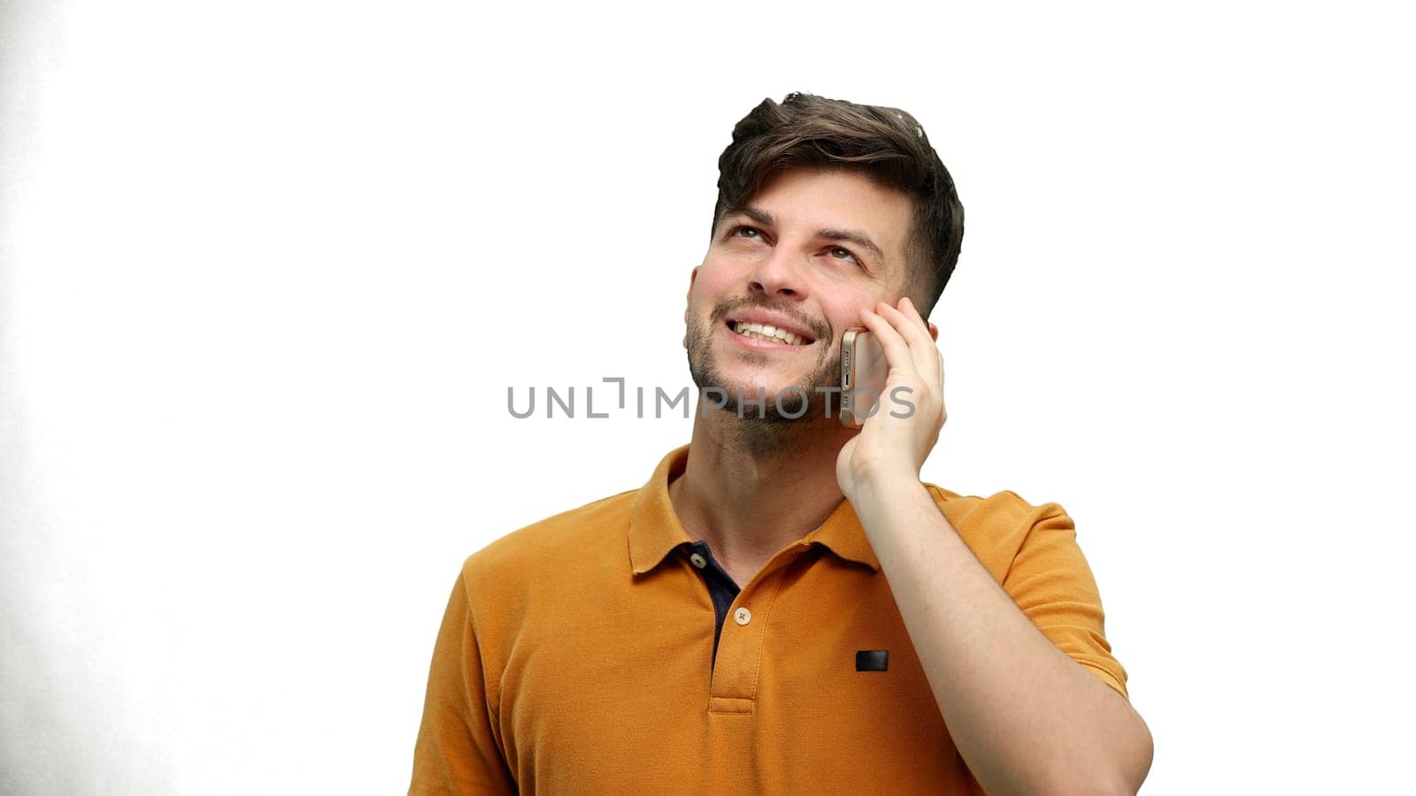 Man, close-up, on a white background, talking on the phone.