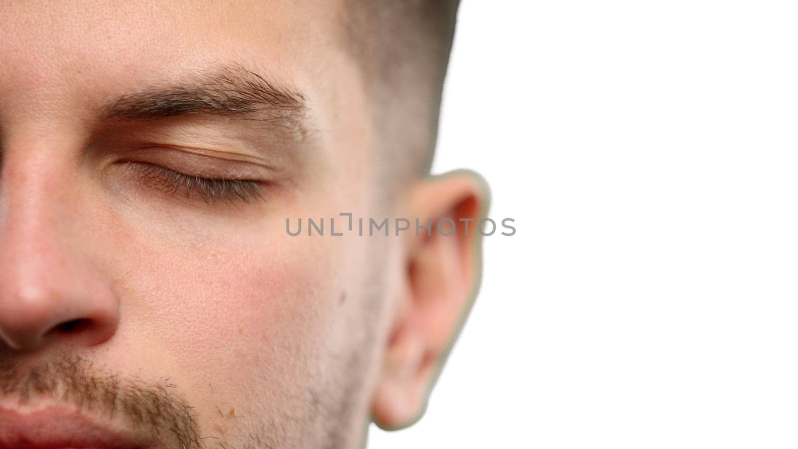 Man's face, close-up, on a white background.