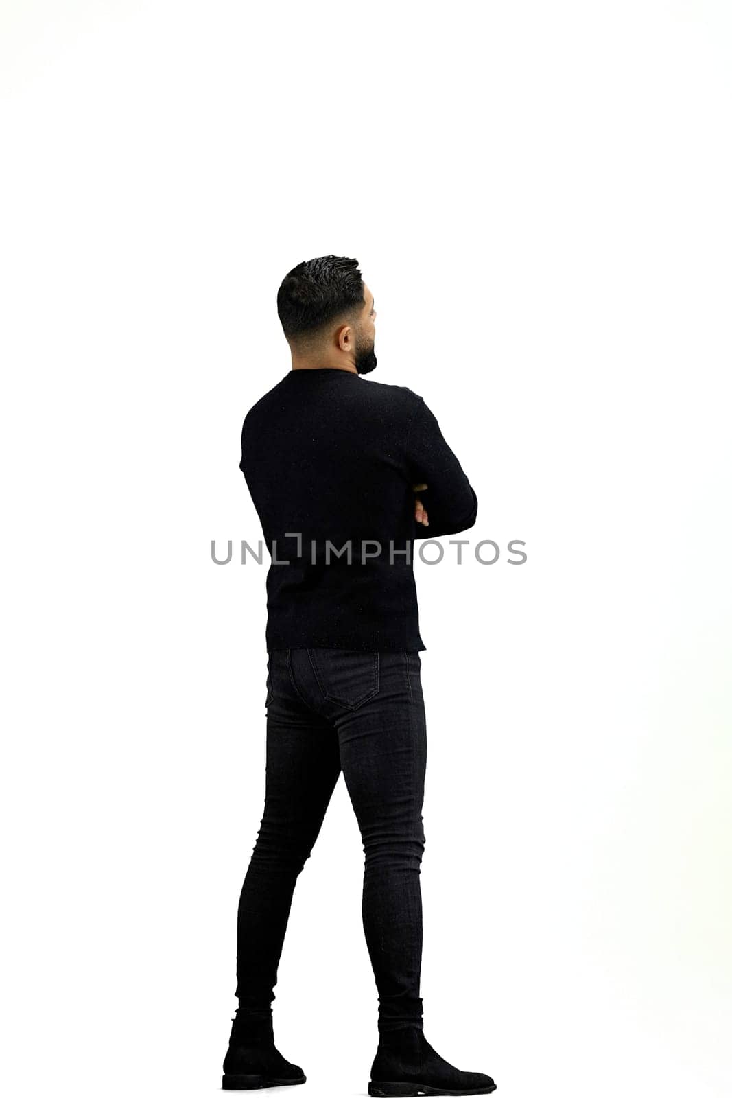 A man, full-length, on a white background, crossed his arms.