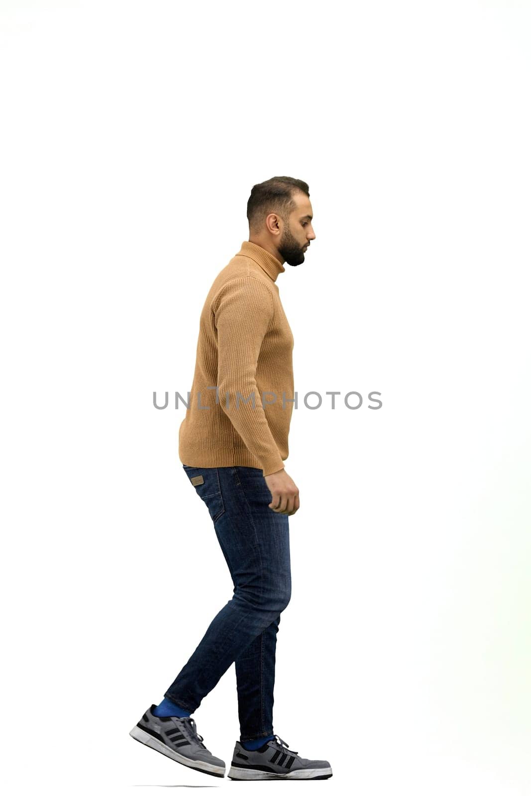 A man, full-length, on a white background, is walking.