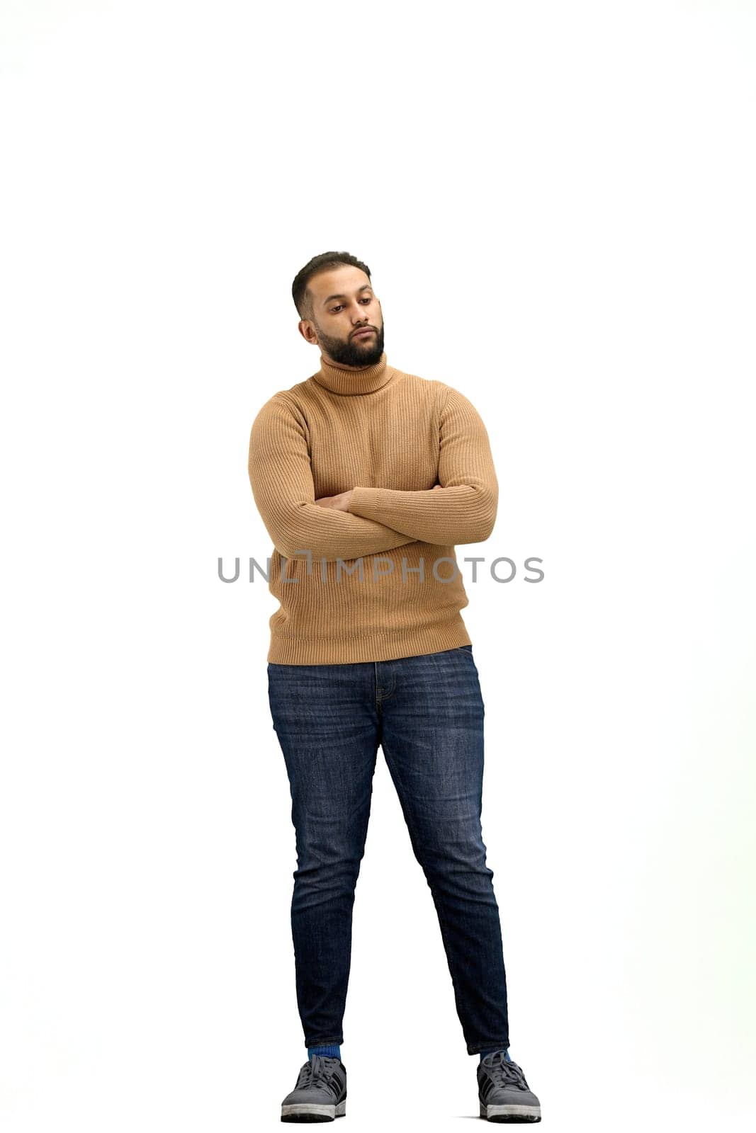 A man, full-length, on a white background, crossed his arms.