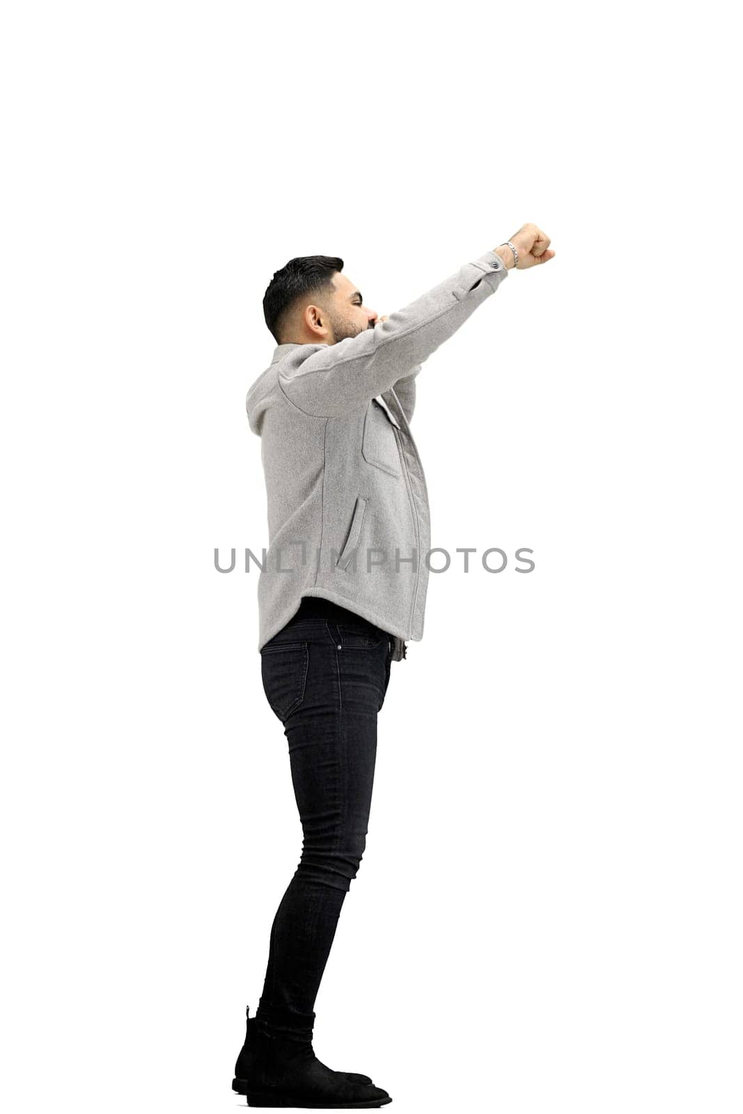 A man, full-length, on a white background, rejoices.