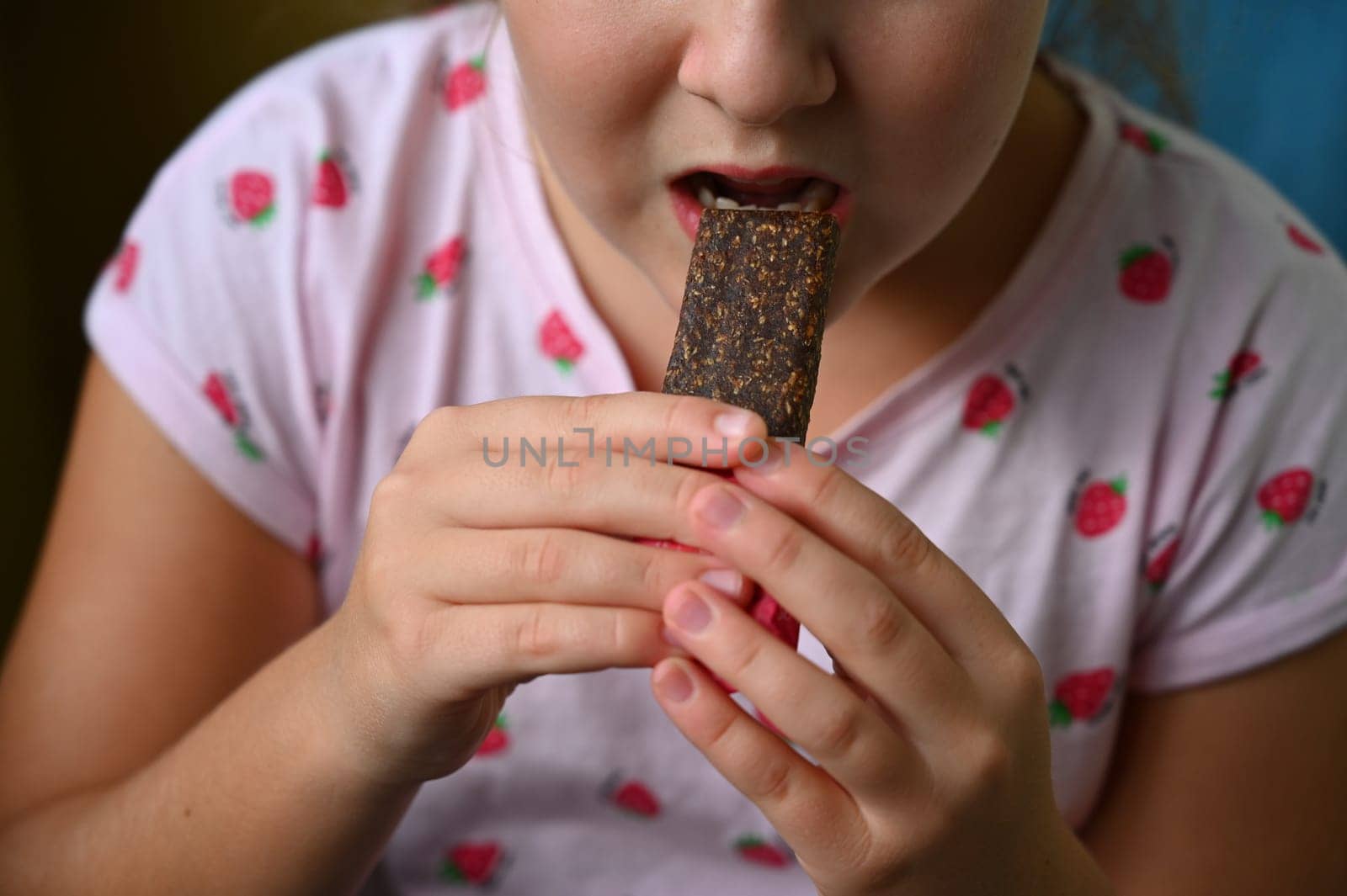 Young girl - child eating candy and sweets. Detail of face and mouth. Concept for healthy lifestyle - healthy - unhealthy sweet food and sugar.