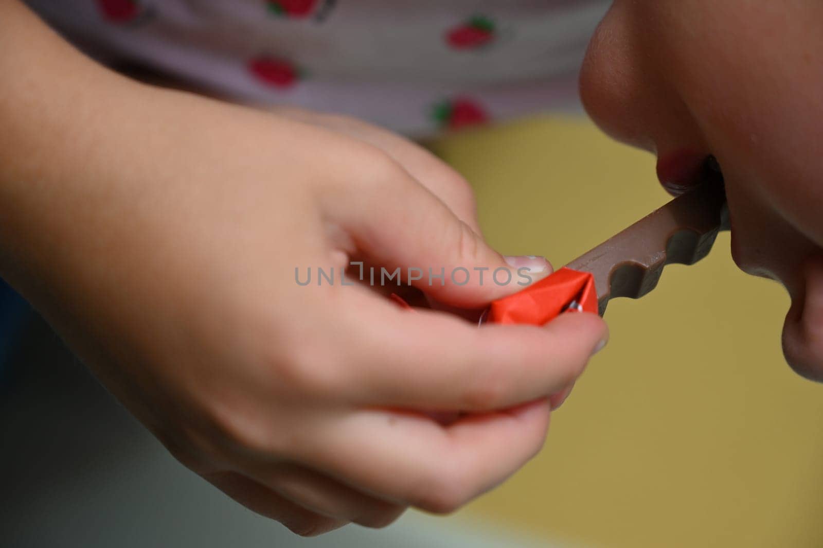 Young girl - child eating candy and sweets. Detail of face and mouth. Concept for healthy lifestyle - healthy - unhealthy sweet food and sugar.