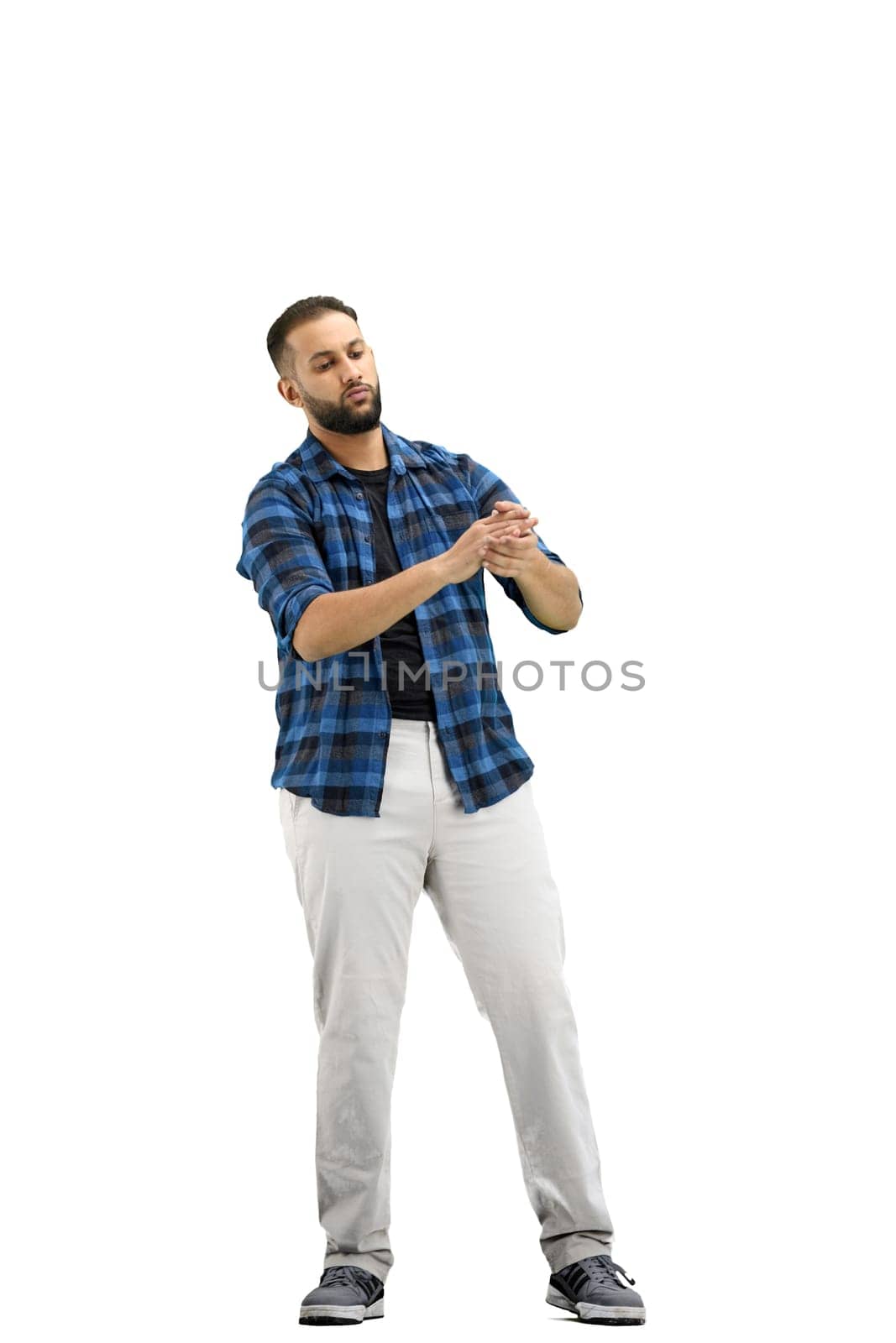 A man, full-length, on a white background, claps.