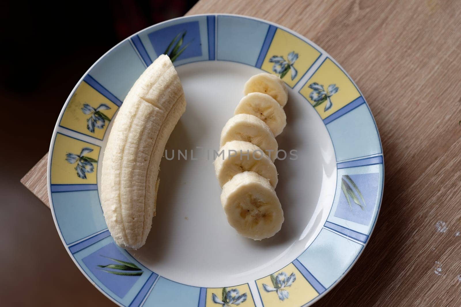 banana on white plate by Montypeter