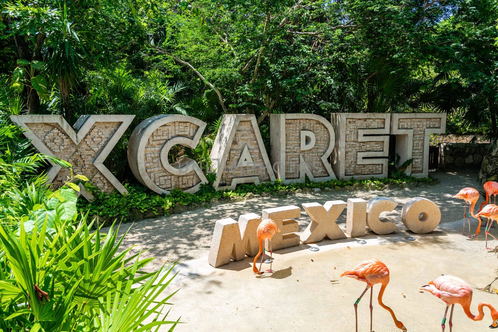Cancun, Mexico - September 13, 2021: Xcaret theme park entrance sign with pink flamingo in Mexico by Mariakray