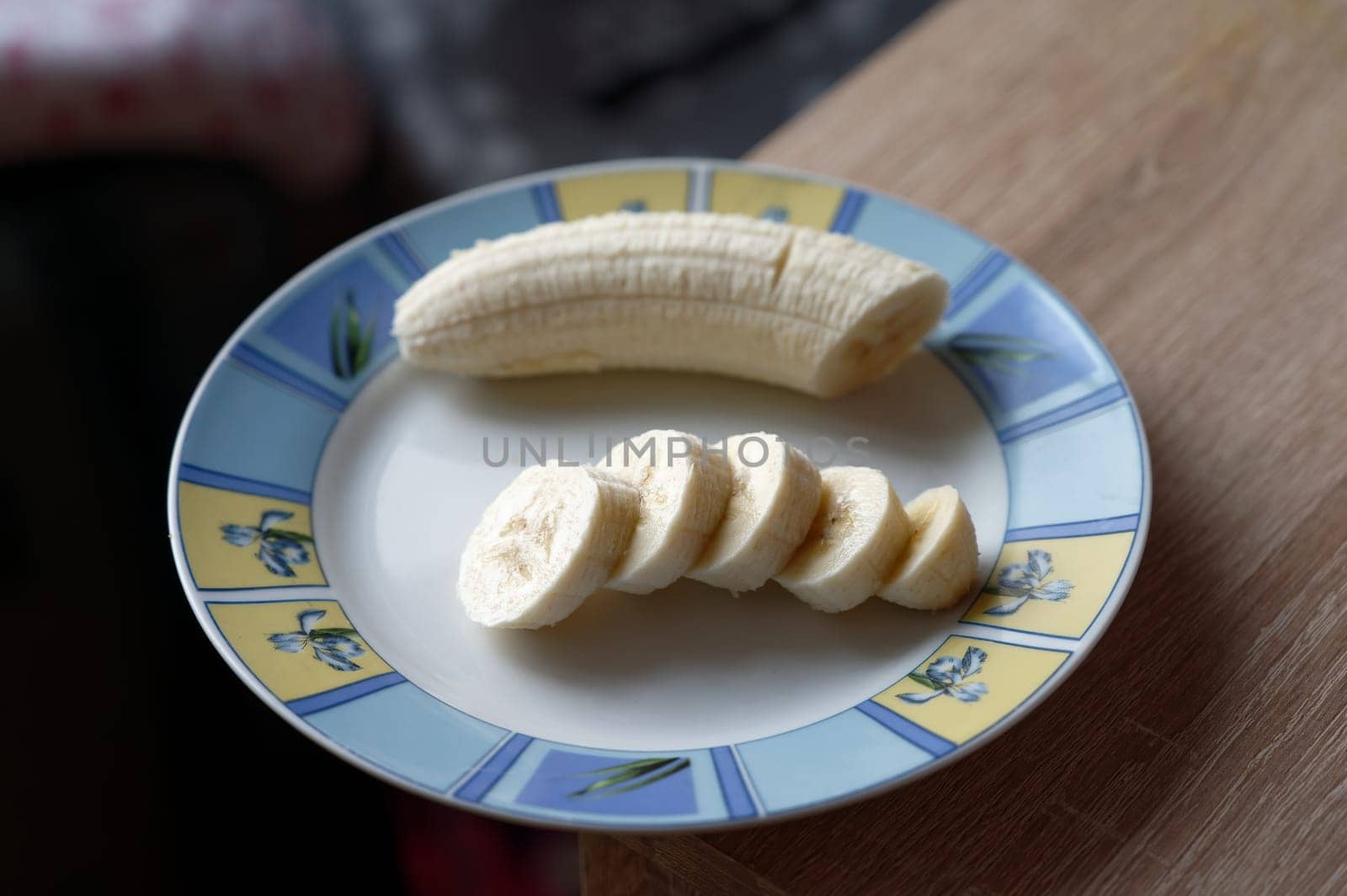 banana on white plate by Montypeter