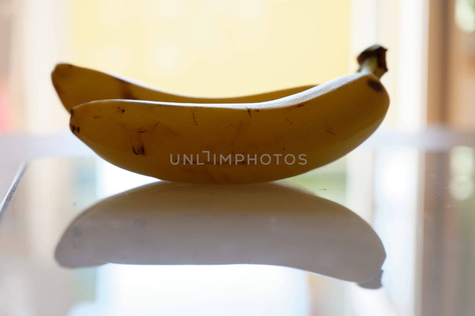 banana on white plate by Montypeter