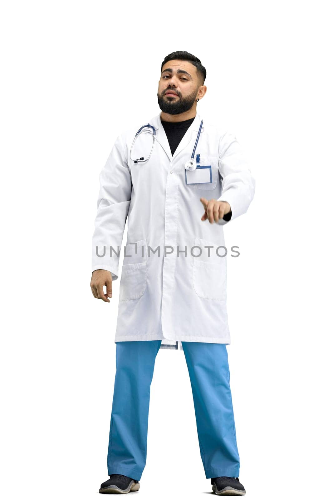The doctor, in full height, on a white background, shows a forbidding sign.