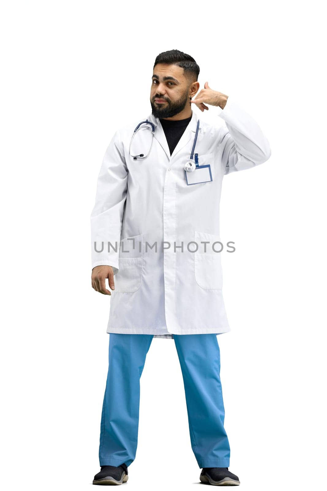 The doctor, in full height, on a white background, shows a call sign.