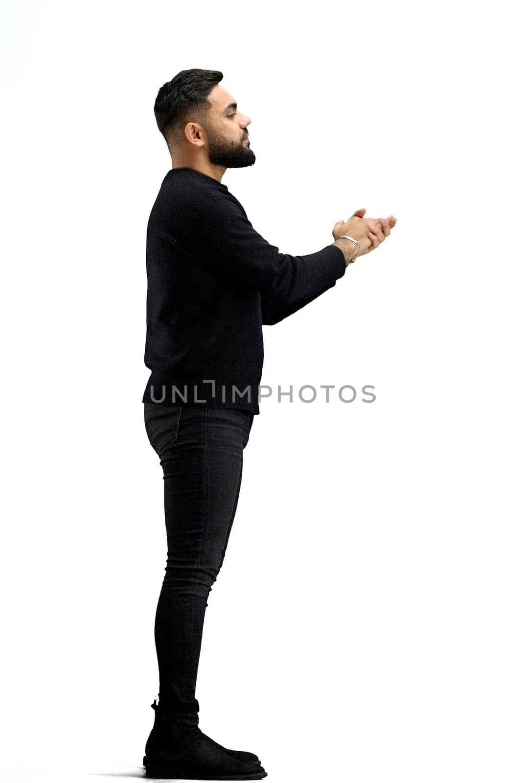 A man, in full height, on a white background, claps.