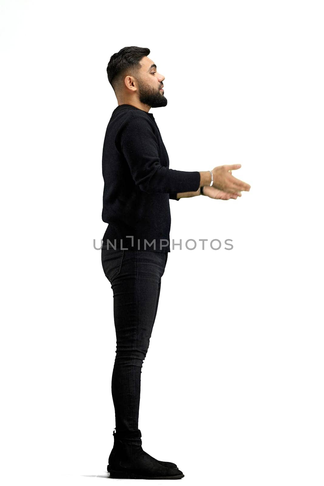 A man, in full height, on a white background, spreads his hands.