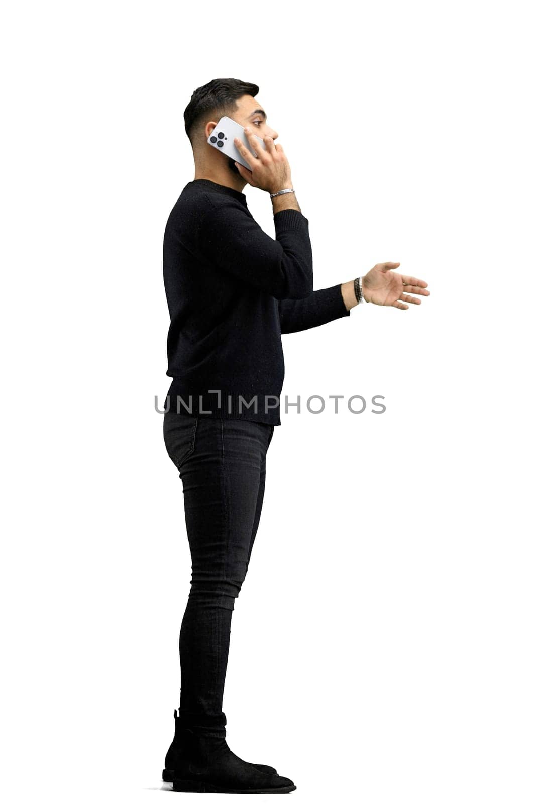 A man, full-length, on a white background, talking on the phone.