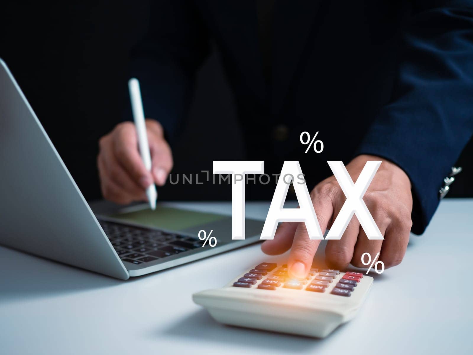 Businessman using computer and calculator for tax calculation, online personal tax return form for tax payment, financial research report, tax return calculation. by Unimages2527