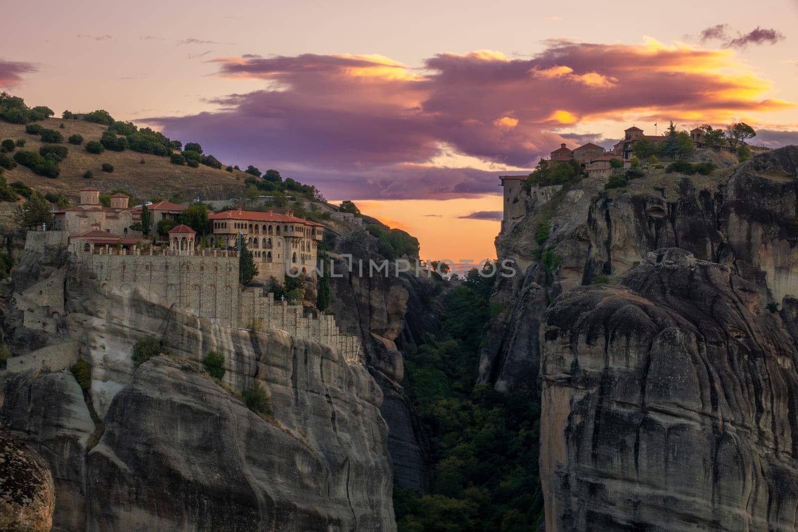 Greece. Summer evening in Kalambaka. Two rock monasteries against the backdrop of an amazing sunset sky