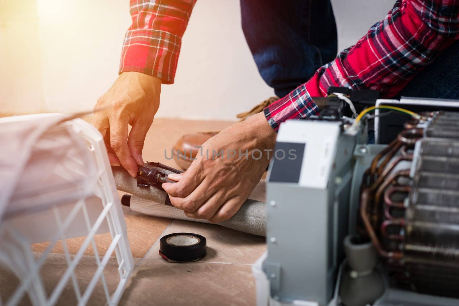 Air conditioning service, repair & maintenance concept. closeup at technician's hand.