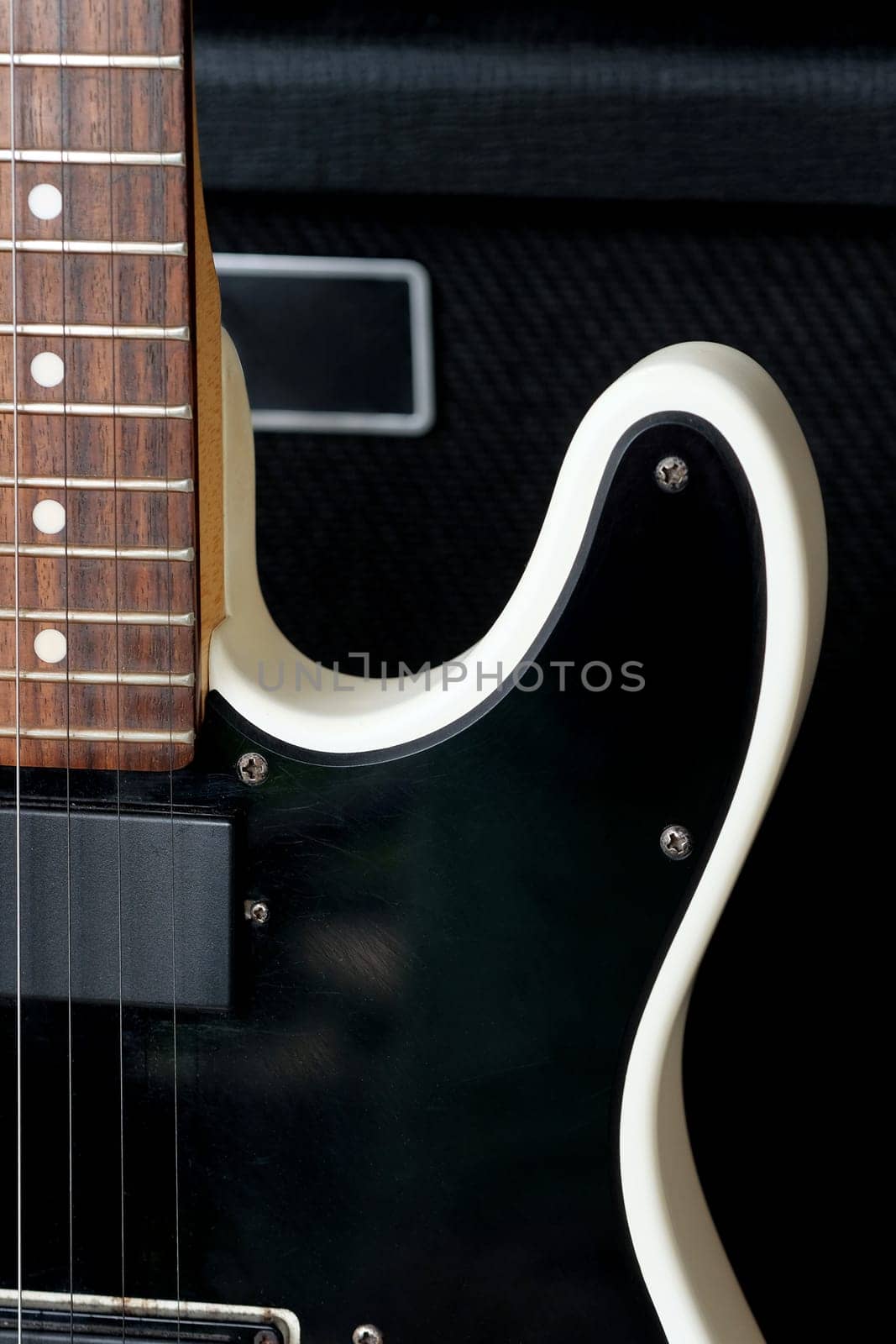 Electric guitar on the background of a guitar amplifier. Musical instrument.