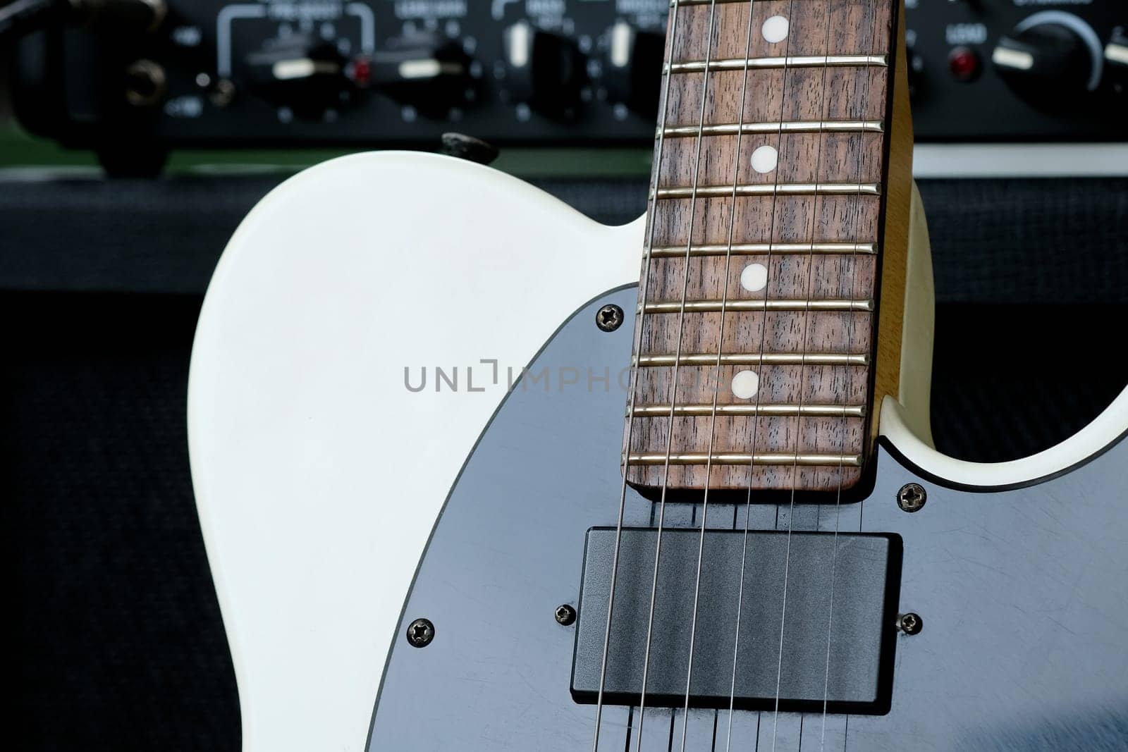 Electric guitar on the background of a guitar amplifier. Musical instrument.