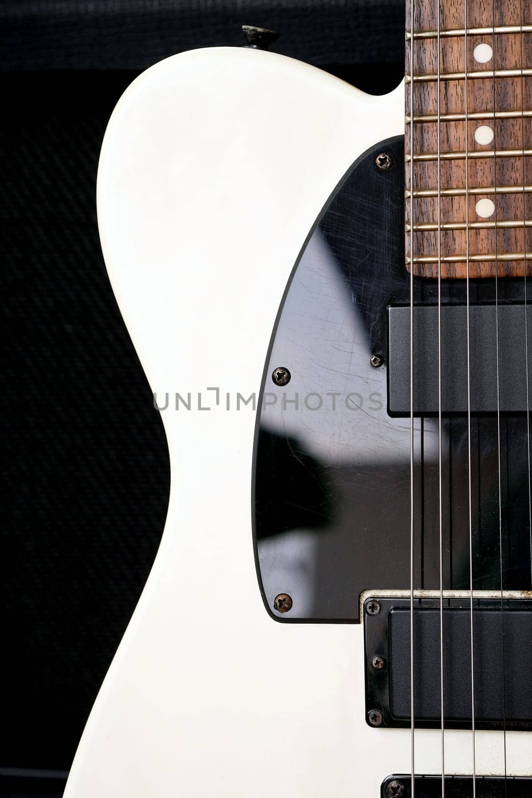 Electric guitar on the background of a guitar amplifier. Musical instrument.