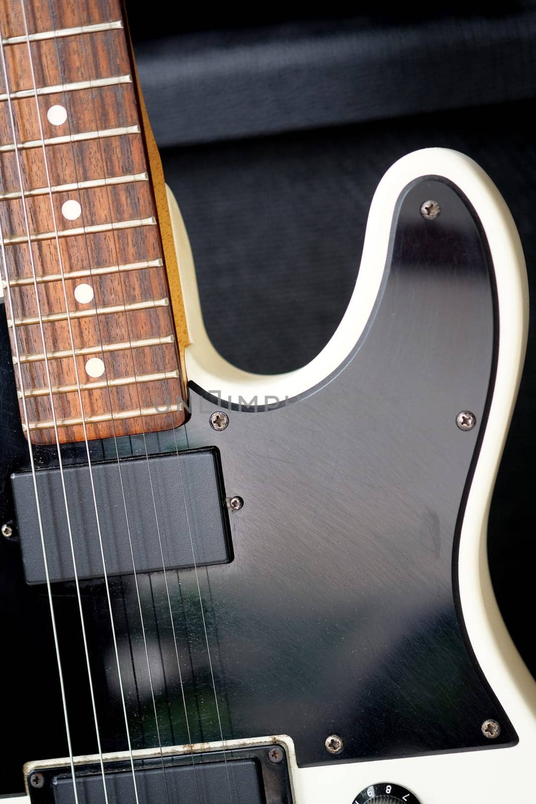 Electric guitar on the background of a guitar amplifier. Musical instrument.