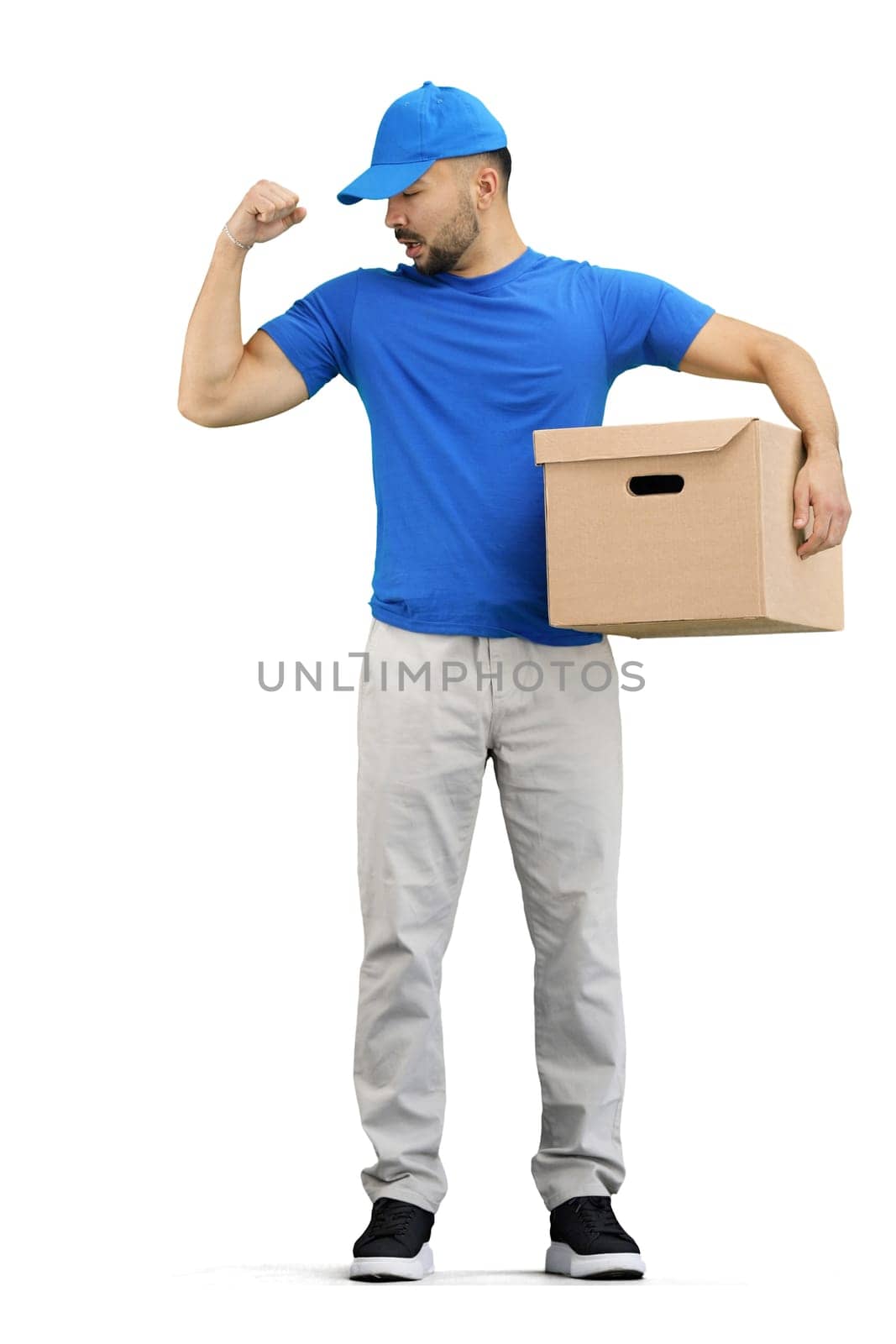 The deliveryman, in full height, on a white background, with a box, shows strength by Prosto