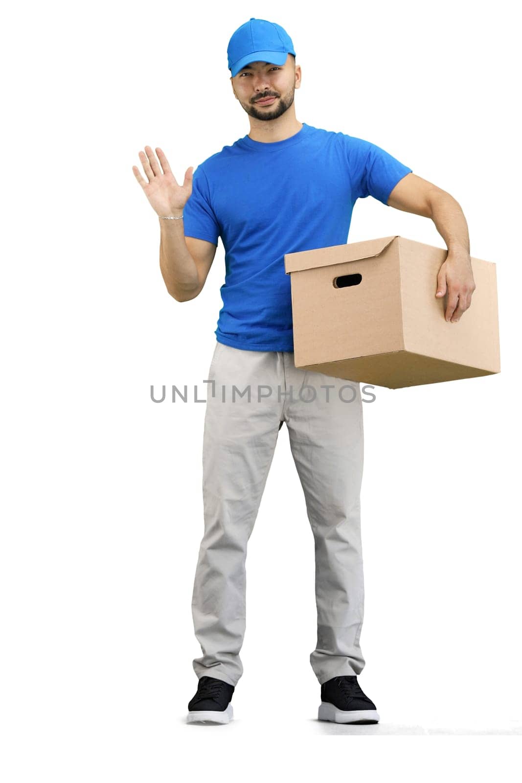 The deliveryman, in full height, on a white background, with a box, waving his hand.