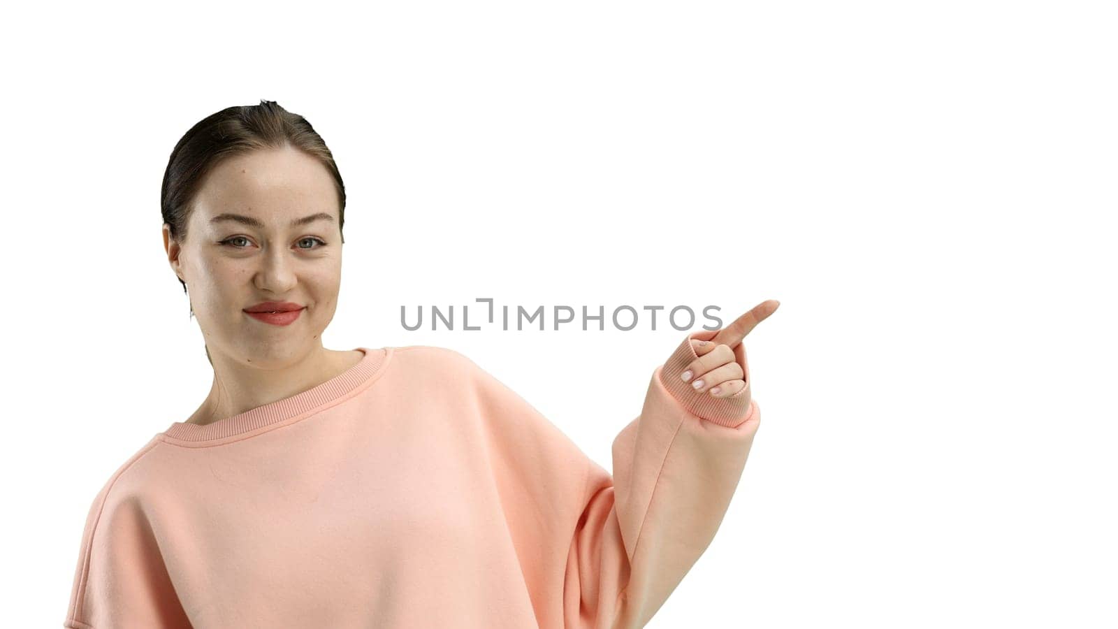 A woman, close-up, on a white background, points to the side by Prosto