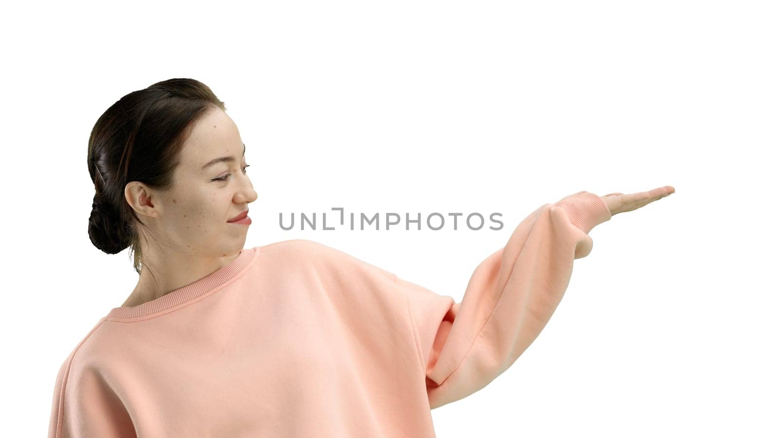A woman, close-up, on a white background, points to the side by Prosto