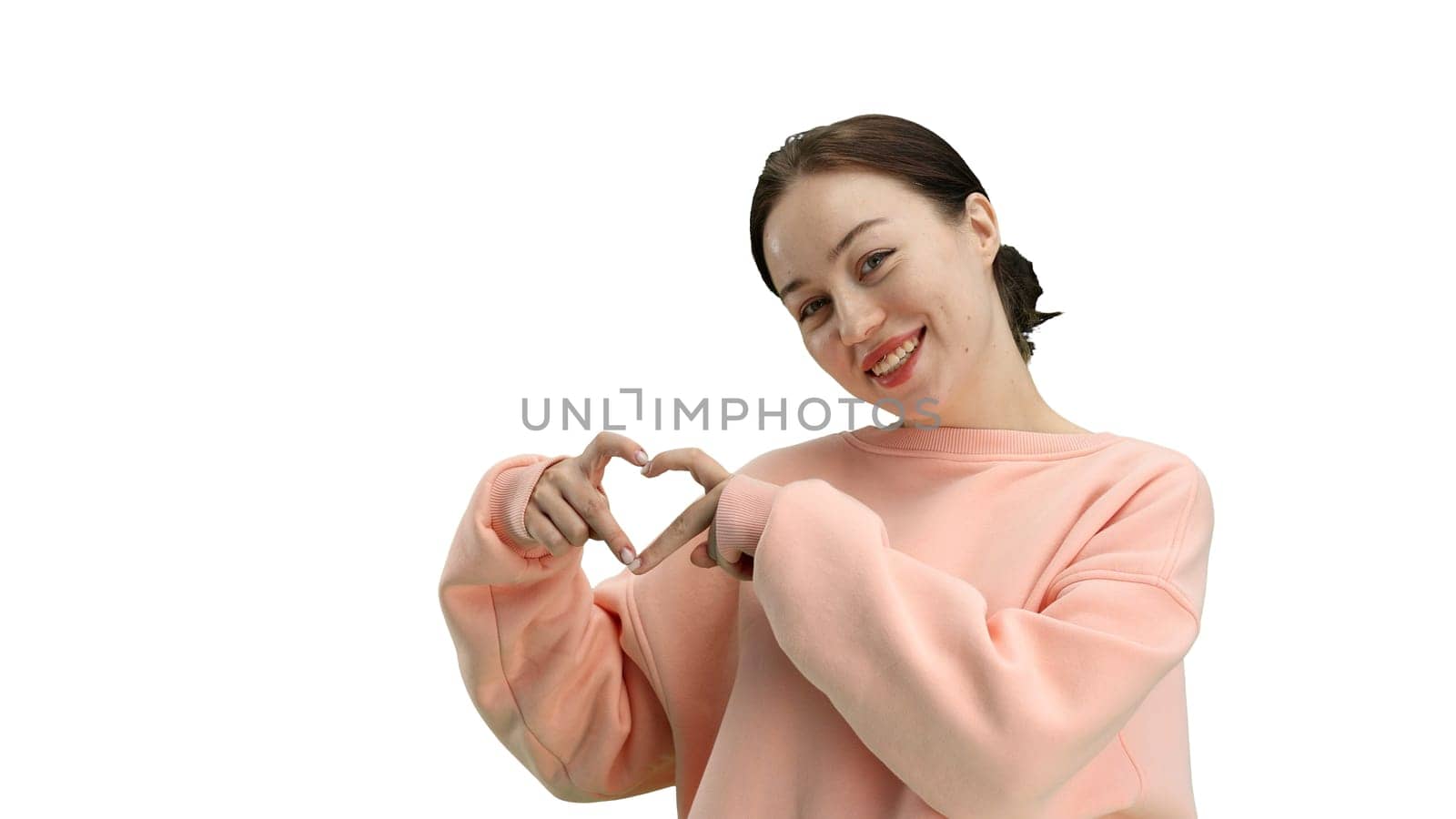 A woman, close-up, on a white background, shows a heart.