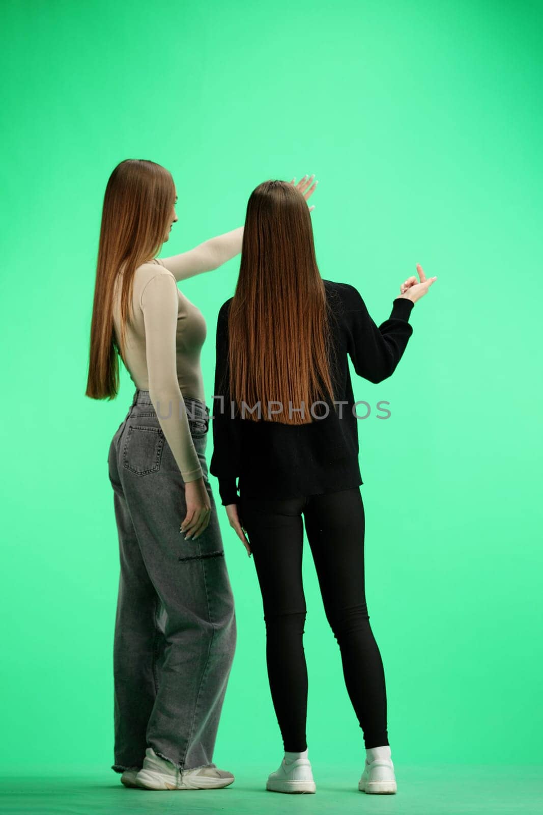 A women, in full-length, on a green background, talking by Prosto