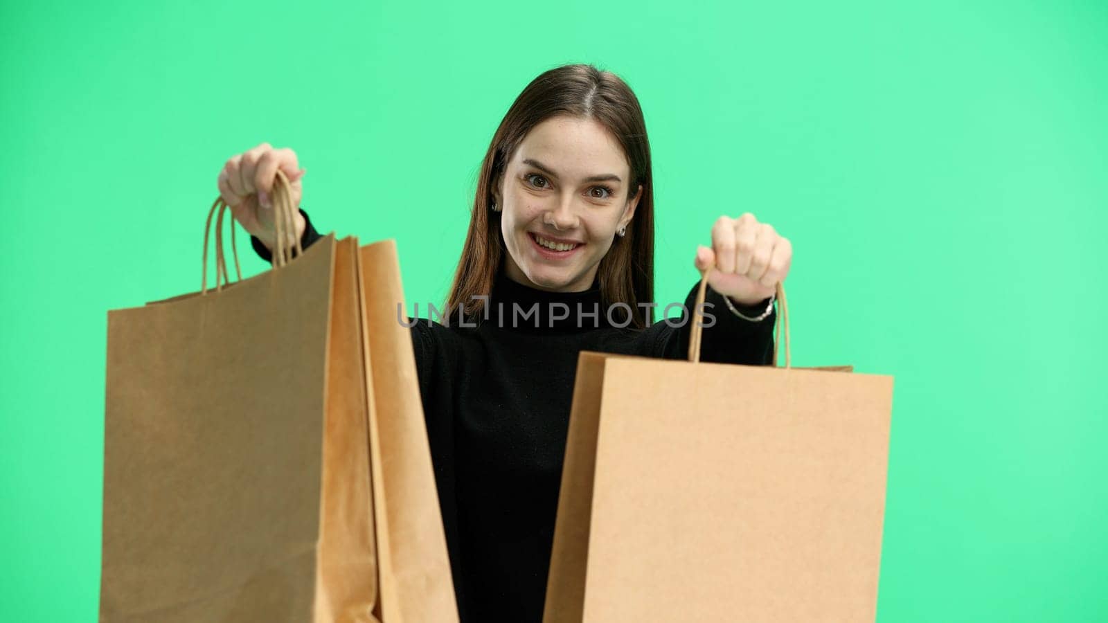 Woman, close-up, on a green background, with bags.