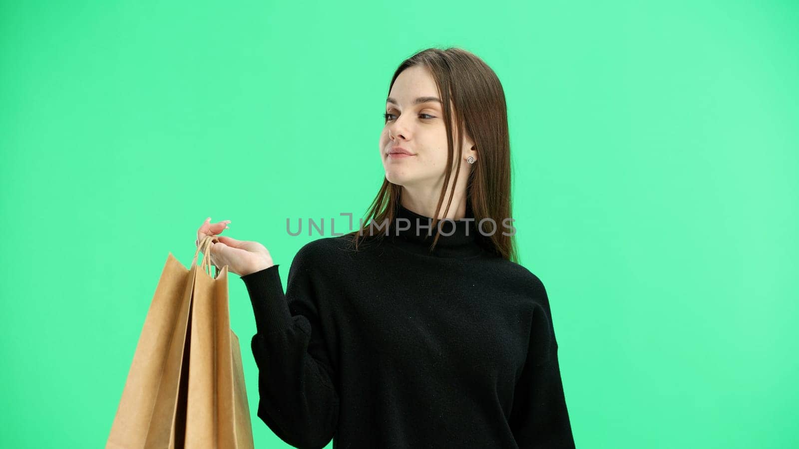 Woman, close-up, on a green background, with bags.