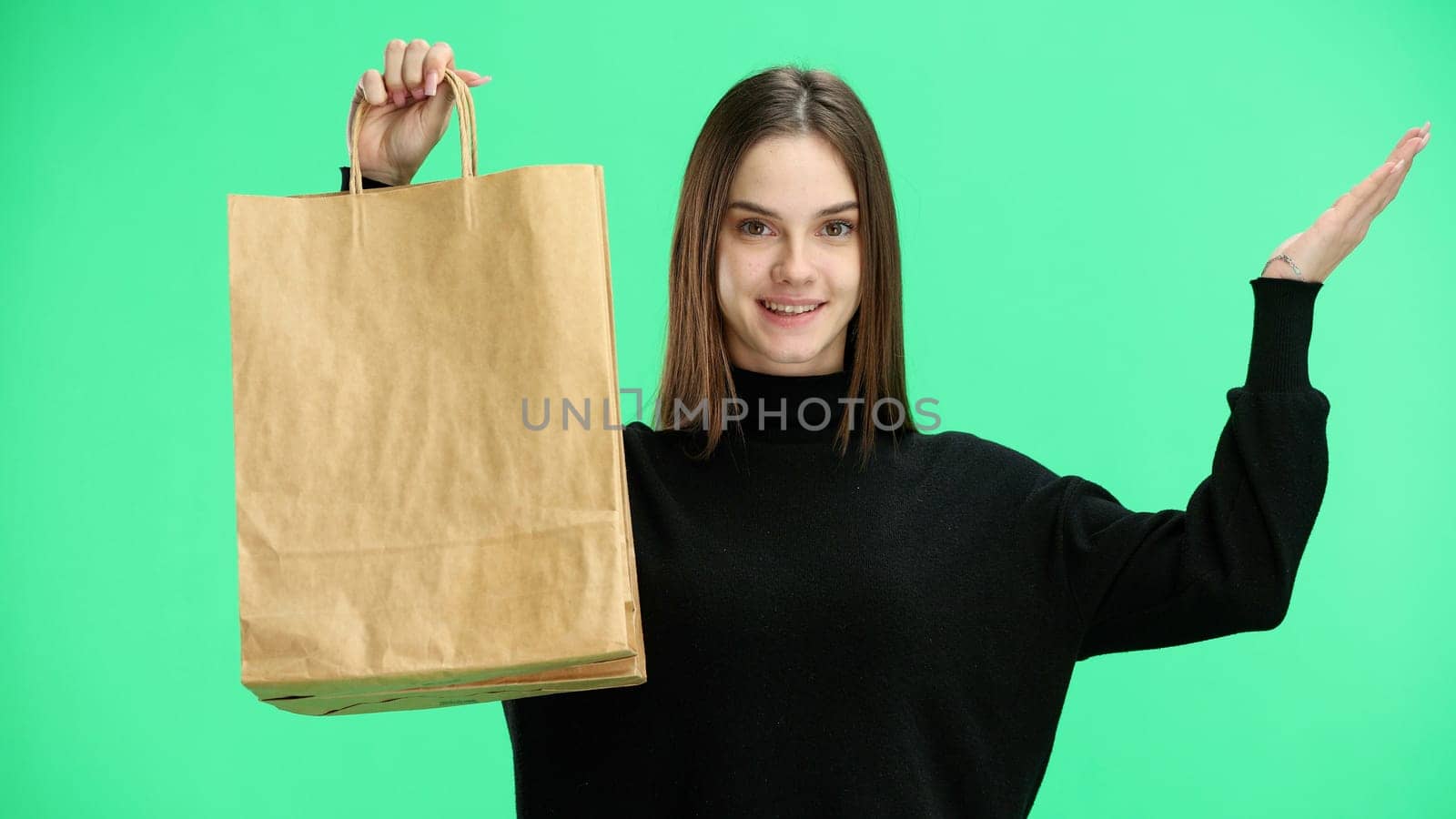 Woman, close-up, on a green background, with bags.