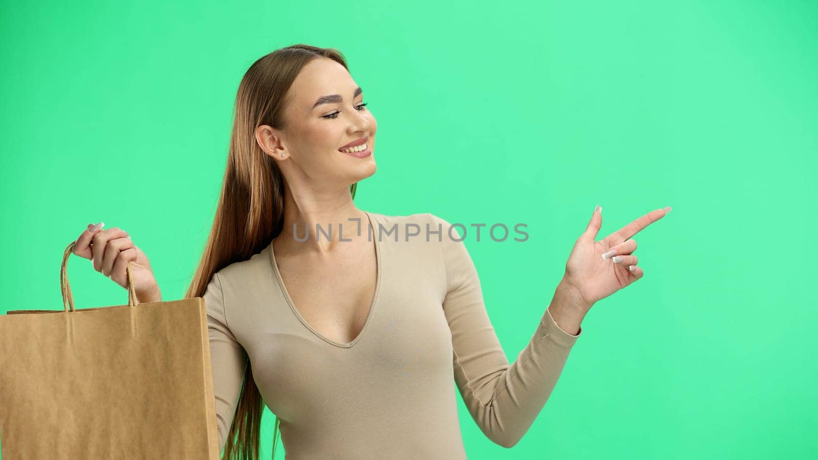 Woman, close-up, on a green background, with bags.