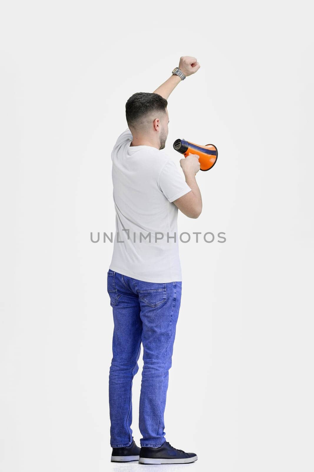 A man, full-length, on a white background, with a megaphone.