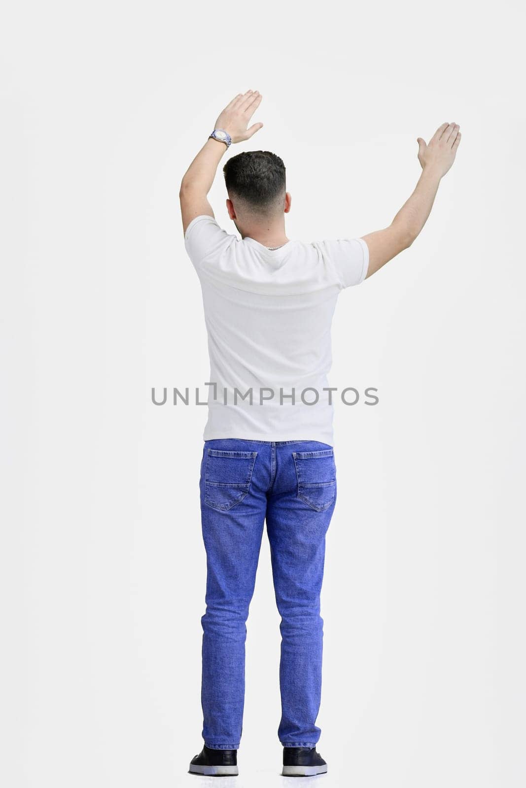 A man, full-length, on a white background, waving his arms.