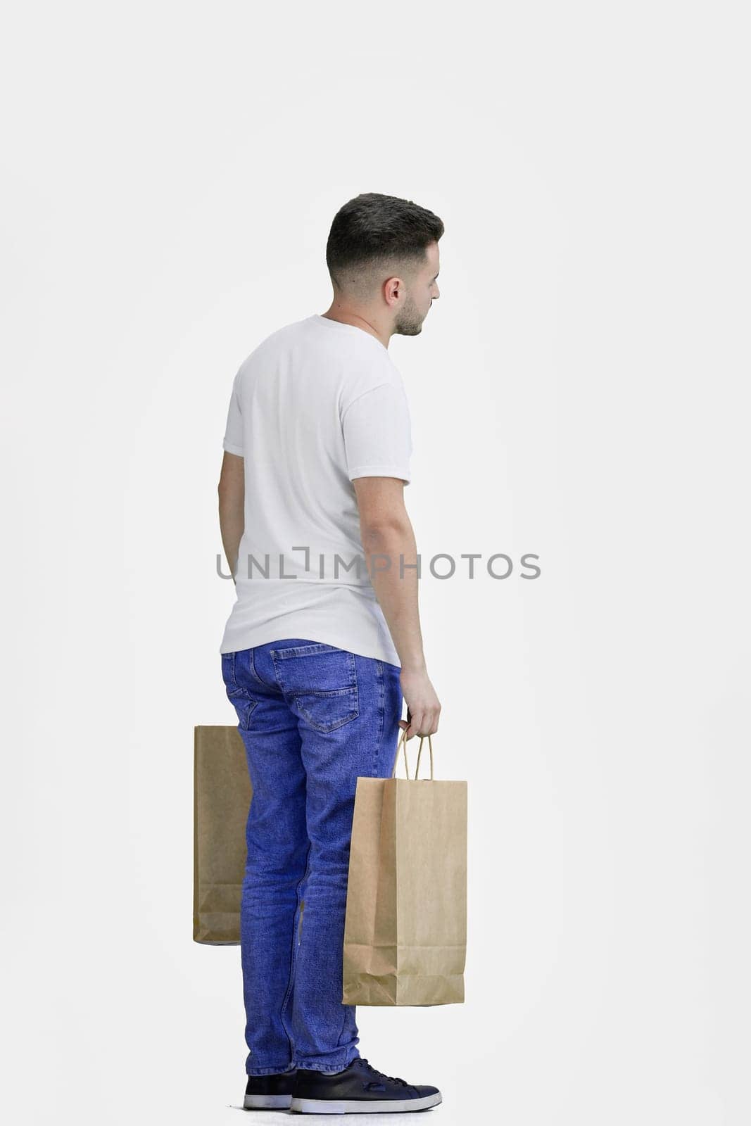 A man, full-length, on a white background, with bags.