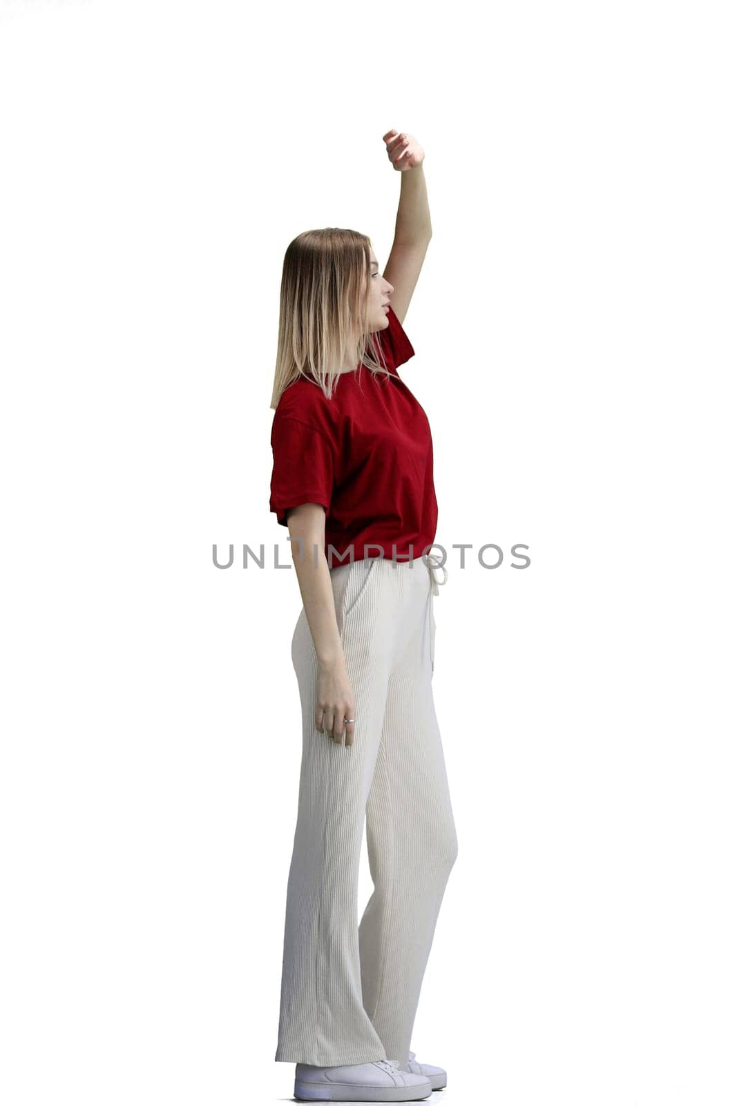 A woman, full-length, on a white background, raised her hand up.