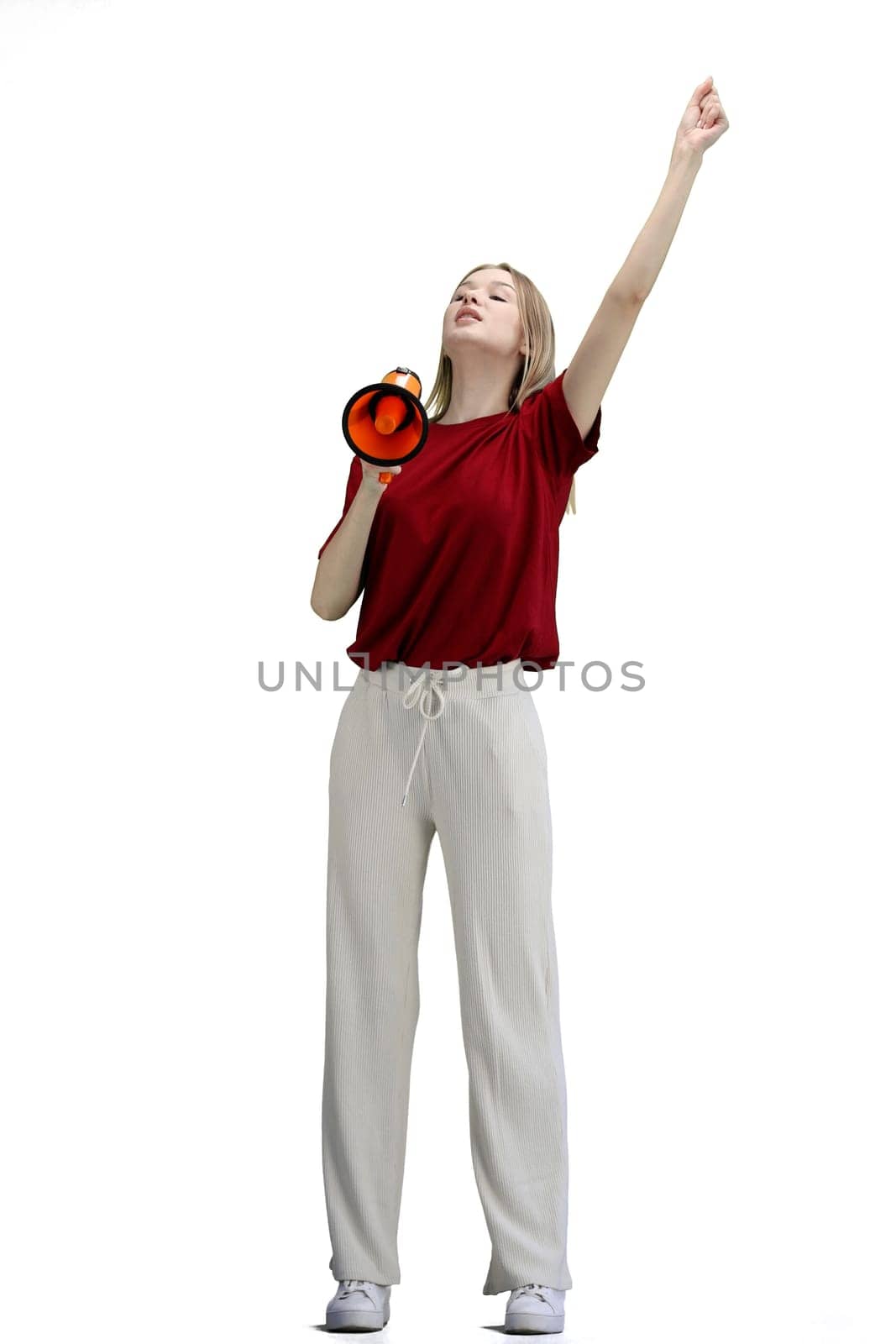 A woman, full-length, on a white background, with a megaphone.