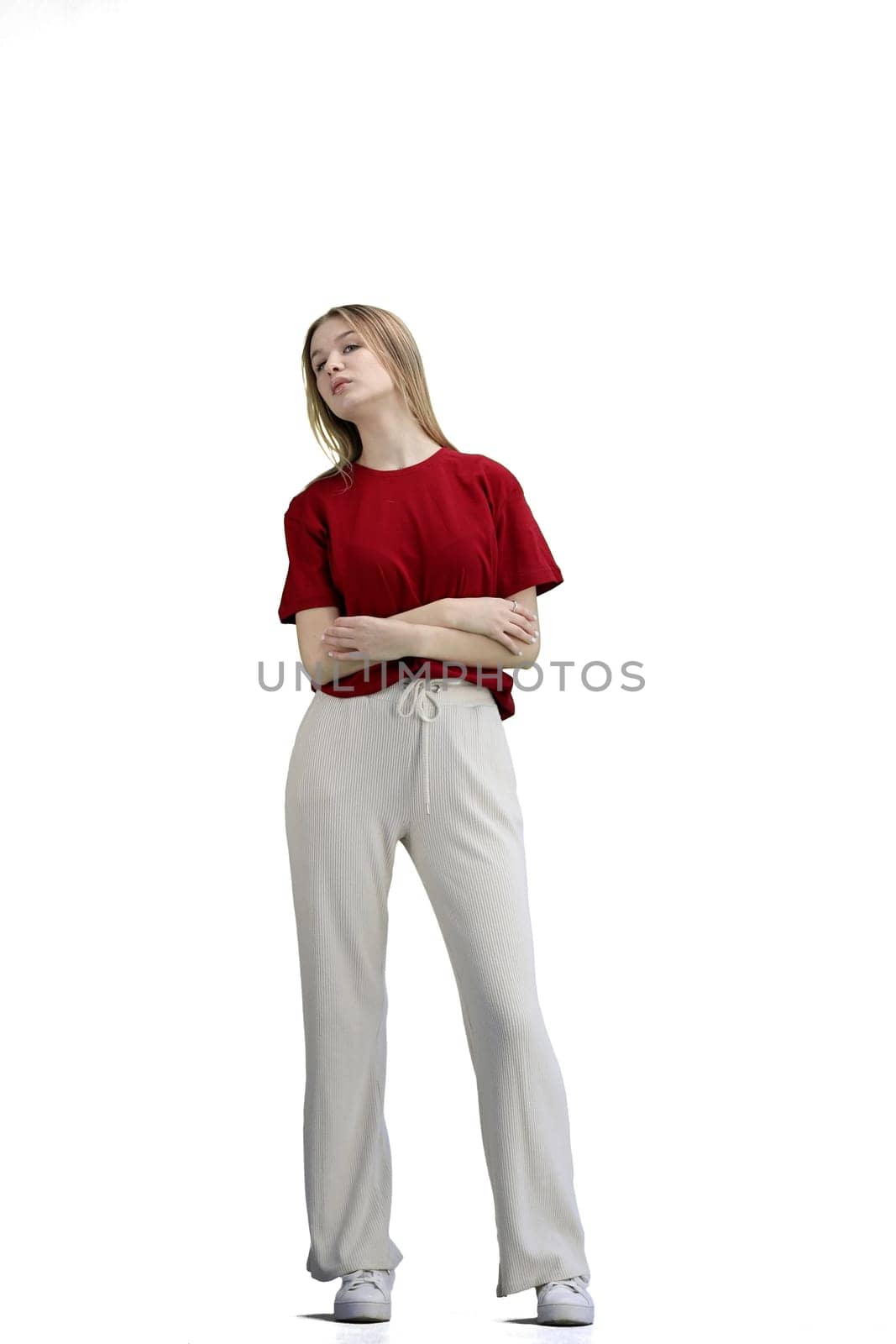 A woman, full-length, on a white background, crossed her arms.