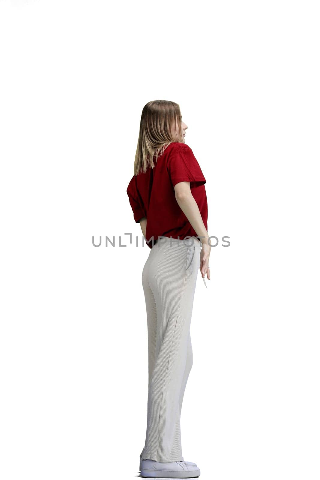 A woman, full-length, on a white background, raised her hand up.