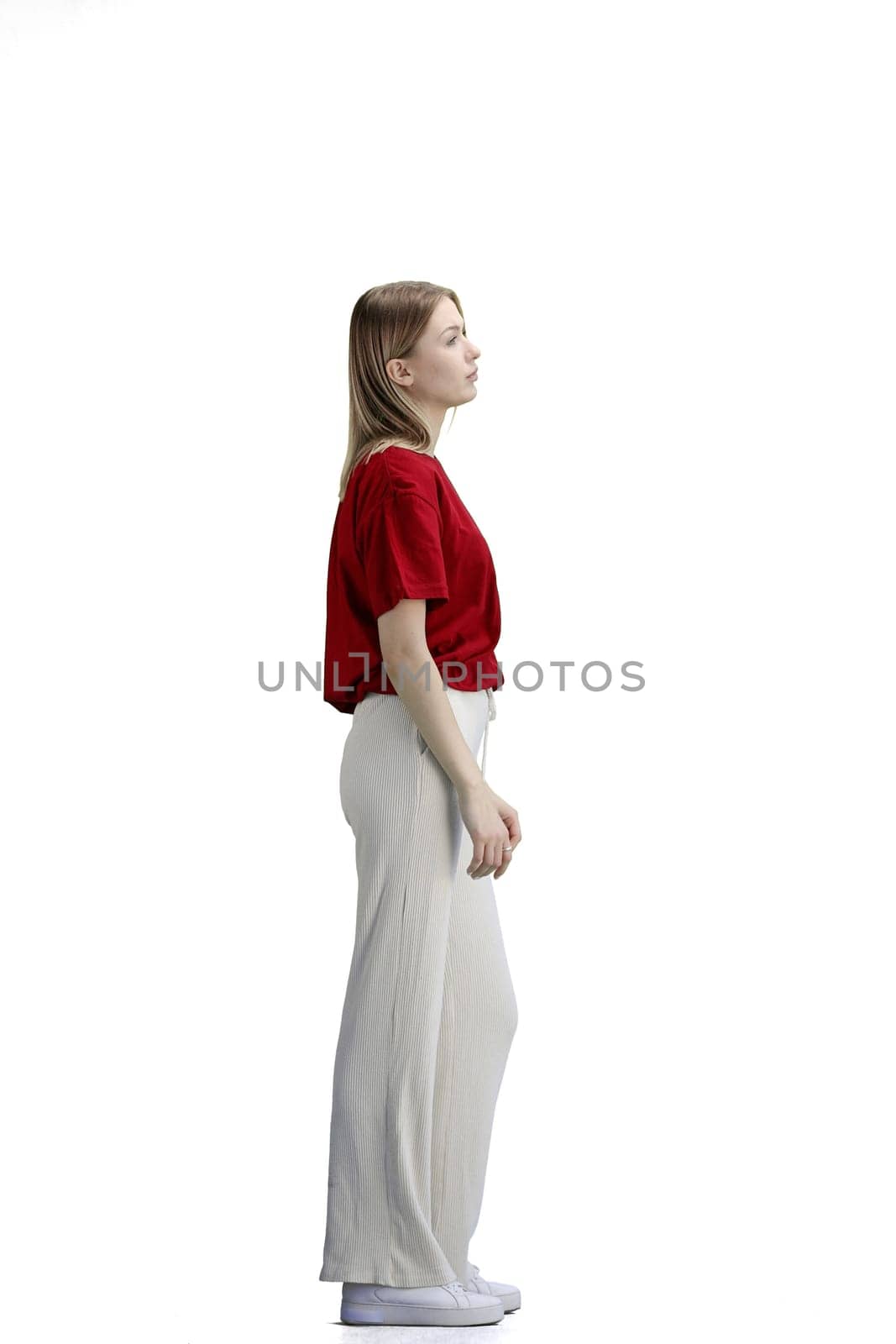 A woman, full-length, on a white background, tired.
