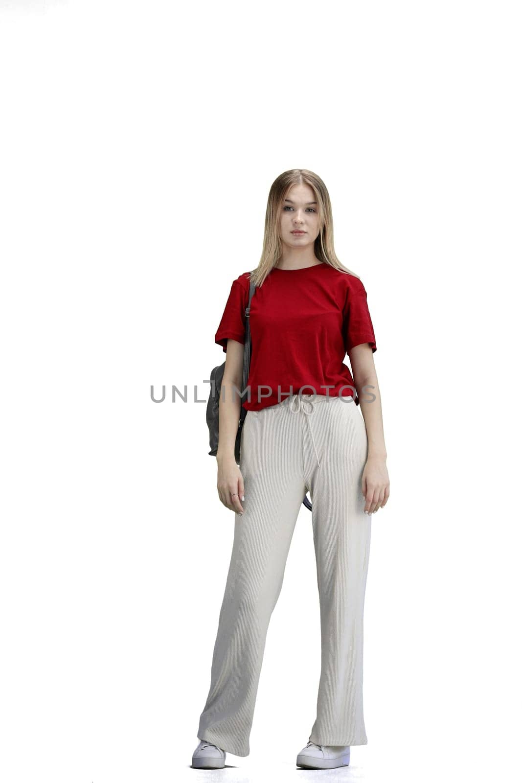 A woman, full-length, on a white background, with a backpack.