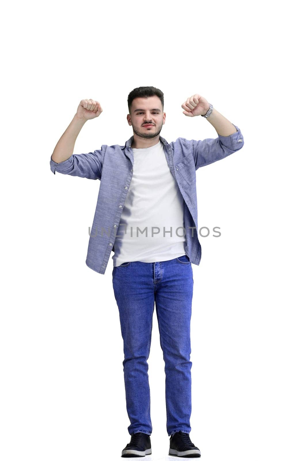 A man, full-length, on a white background, raised his hands up.