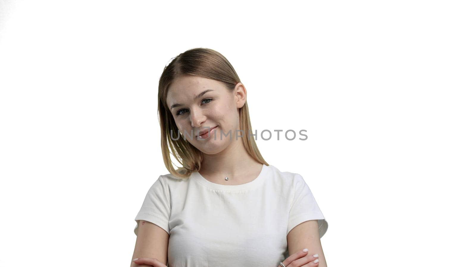 A woman, close-up, on a white background, crossed arms.