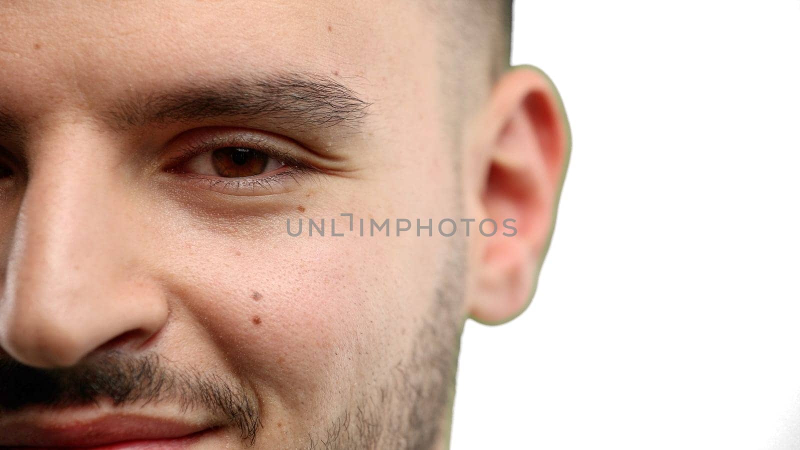 Man's face, close-up, on a white background.