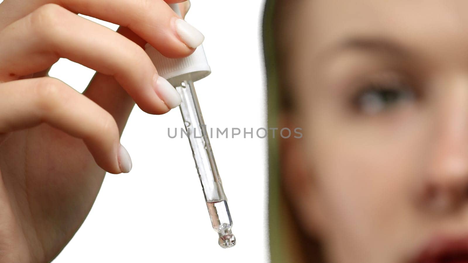 Woman's face, close-up, on a white background.