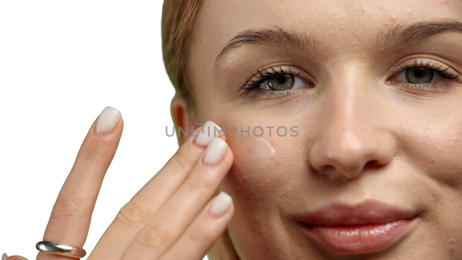 Woman's face, close-up, on a white background.